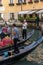 Venice, Italy - 01 July 2018: The gondolas parked with gondolier near bridge in Venice, Italy