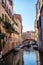 Venice, Italy - 30 June 2018: The gondolas parked with gondolier near bridge in Venice, Italy