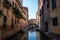 Venice, Italy - 30 June 2018: The gondolas parked with gondolier near bridge in Venice, Italy