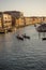 Venice, Italy - 30 June 2018: Gondolier taking tourists on a Gondola ride along the grand canal near Rialto Hotel in Venice, Italy