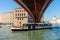 Venice, Italy - 30 June 2018: The taxi boat below underside bottom of a modern bridge on a grand canal in Venice, Italy