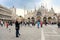 VENICE, ITALY - APRIL 24, 2019: Tourists on famous square of Venice - piazza San Marco with basilica San Marco after rain