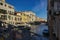 Venice, Italy: Arch bridge linked to jewish ghetto over the Canal and a motor boat sailing against typical