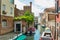 VENICE, ITALY - August 02, 2019: One of the thousands of lovely cozy corners in Venice on a clear sunny day. Locals and tourists