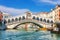 Venice,Italy - August 22, 2018: The Rialto Bridge and many tourists on a summer day