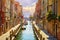 Venice, Italy. Boats parked near brick walls of houses at street