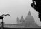 Venice, Italy, December 28, 2018 Panoramic view of a Venice canal with dome in the background and flying seagull in the foreground