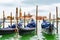 Venice, Italy. Empty Gondolas/ Gondole docked by lagoon mooring poles.