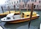 Venice, Italy, January 27, 2020 ambulance first aid motorboats moored in the docking point with wooden poles