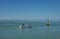 VENICE, ITALY - Jun 19, 2018: Three men in a small boat on the lagoon, in Venice, Italy