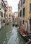 Venice, Italy - June 30, 2017: A view of the colorful Venetian houses, Gondola docked along a canal in Venice in Venice