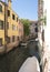 Venice, Italy - June 30, 2017: A view of the colorful Venetian houses, Gondola docked along a canal in Venice in Venice