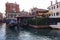 Venice, Italy: A man rowing a gondola with tourist through a famous jewish ghetto area against residential