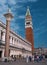 Venice, Italy - May 08, 2018: The column of St. Theodore and the bell tower of St. Mark-Campanile-in the center of