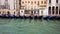 VENICE, Italy - May 2019: many gondolas moored near the shore. Grand Canal Street. Evening time. lanterns lit up. Slow