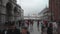 VENICE, ITALY - MAY 2019: VENICE, ITALY - MAY 2019: huge cruise ship liner sails into the lagoon. Tourists are walking