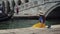 Venice, Italy - May 21, 2019: Woman in hat sits on pier, splashes water by legs