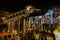 Venice, Italy night view of Ponte di Rialto, Rialto pedestrian Bridge with a gondolier next to wooden wharf pilings.