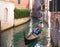 VENICE, ITALY - OCTOBER, 07 2017 Tourists travel on gondola on small canal