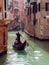 VENICE, ITALY - OCTOBER 8 , 2017: Gondolier floats on the narrow channel in Venice, Italy