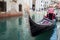 VENICE, ITALY - OCTOBER 8 , 2017: Gondolier floats on the narrow channel in Venice, Italy