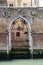 Venice, Italy. Old arched water door off a canal in a weathered brick wall