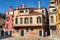 Venice, Italy. Old house with chimneys and green shutters