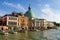 Venice, Italy panorama on beautiful day with small narrow streets, canals and boats and gondolas floating under bridges.