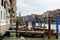 Venice, Italy panorama on a beautiful day with small narrow streets, canals and boats and gondolas floating under bridges.
