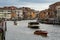 Venice, Italy panorama on a beautiful day with small narrow streets, canals and boats and gondolas floating under bridges.