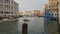 Venice, Italy a seagull standing on Grand Canal by passing boats.