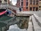 Venice, Italy - September 02, 2018: An unidentified rear angle shot of man wearing Gondola traditional cloths awaiting clients for