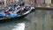 VENICE, ITALY, SEPTEMBER 7, 2017: Venetian gondolas stand on canal in the rain, Beautiful black gondolas stand and rock