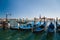 VENICE, ITALY - SEPTEMBER, 9 2018: Gondolas station at Traghetto molo near to the San Marco Square with the San Giorgio