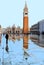 VENICE, ITALY St Mark`s Square full of tourists during a flood with beautiful water reflections of Bells tower