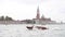 Venice, Italy - A taxi boat moving fast in front of San Giorgio Maggiore church