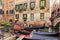 Venice, Italy. Tourists riding gondolas while listening to singer at venetian canal