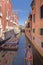 Venice, italy: traditional venice canal scene. gondola and blue sky