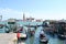 Venice lagoon with a queue of gondolas   with tourists sitting in them and the island of San Giorgio Maggiore.