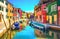 Venice landmark, Burano island canal, colorful houses and boats, Italy