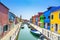 Venice landmark, Burano island canal, colorful houses and boats, Italy