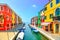 Venice landmark, Burano island canal, colorful houses and boats, Italy
