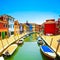 Venice landmark, Burano island canal, colorful houses and boats, Italy