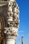 Venice, palace with white ancient sculptures and capital in Italy