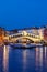 Venice Rialto bridge over Canal Grande with gondola travel traveling holidays vacation town portrait format at night in Italy