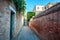 Venice`s narrowest street between brick walls, Italy