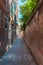 Venice`s narrowest street between brick walls, Italy