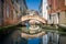 Venice small channel and old curved bridge