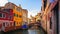 Venice street canal with boat. Picturesque view of narrow Canal in Venice, Italy