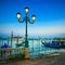 Venice, street lamp and gondolas on sunset. Italy